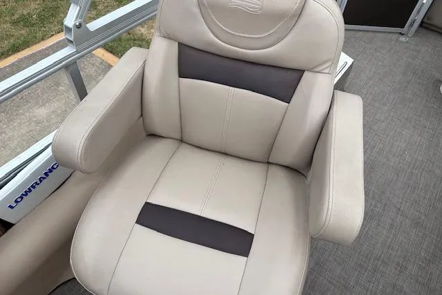 Slide: The Image of 2018 Sun Tracker SportFish 22 XP3 boat seat, beige with dark accents, on deck. - 21