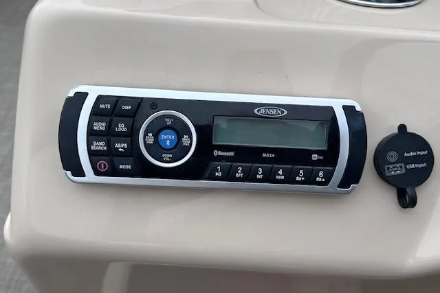 Slide: The Image of Jensen audio system on 2018 Sun Tracker SportFish 22 XP3 boat dashboard. - 22