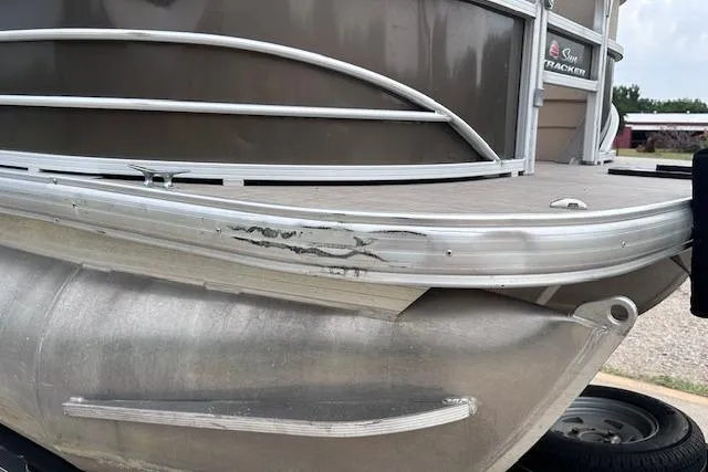 Slide: The Image of 2018 Sun Tracker SportFish 22 XP3 pontoon boat with visible exterior damage. - 31
