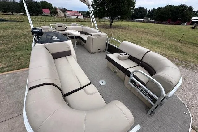 Slide: The Image of 2018 Sun Tracker SportFish 22 XP3 pontoon boat with spacious seating and open deck layout. - 7