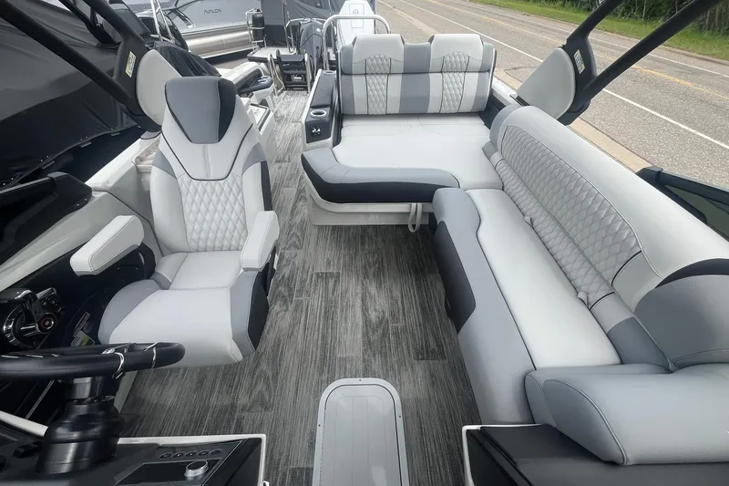 Slide: The Image of Luxurious interior of 2025 Avalon Excalibur Versatile Rear Bench Windshield boat with plush seating. - 12
