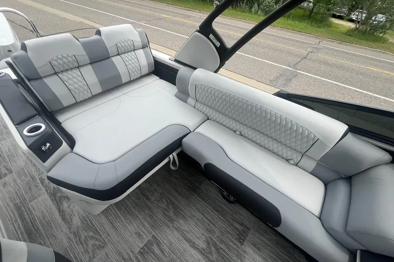 Slide: The Image of Luxurious 2025 Avalon Excalibur boat interior with versatile rear bench and windshield. - 13