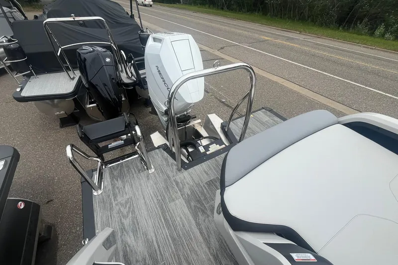 Slide: The Image of 2025 Avalon Excalibur Versatile boat with rear bench and Mercury outboard engine on display. - 16