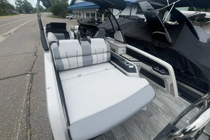 Slide: The Image of 2025 Avalon Excalibur Versatile Rear Bench Windshield boat with luxurious seating and modern design. - 18