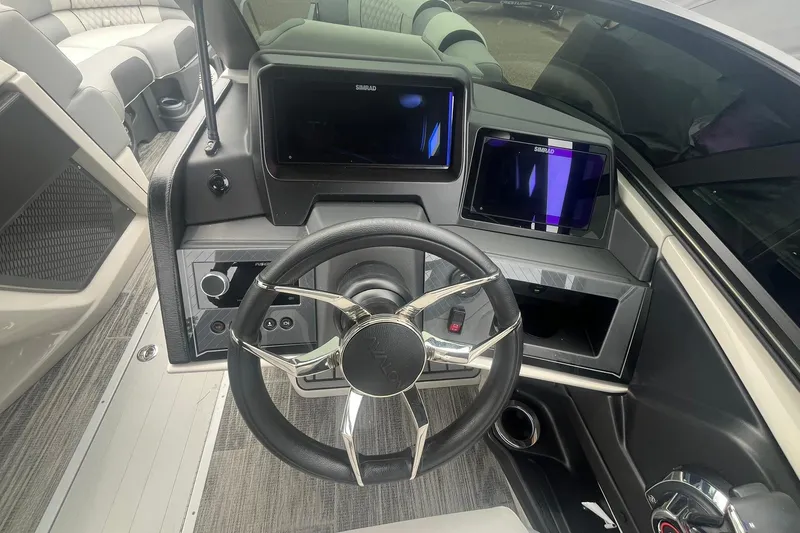 Slide: The Image of 2025 Avalon Excalibur boat dashboard with modern steering and dual displays. - 21