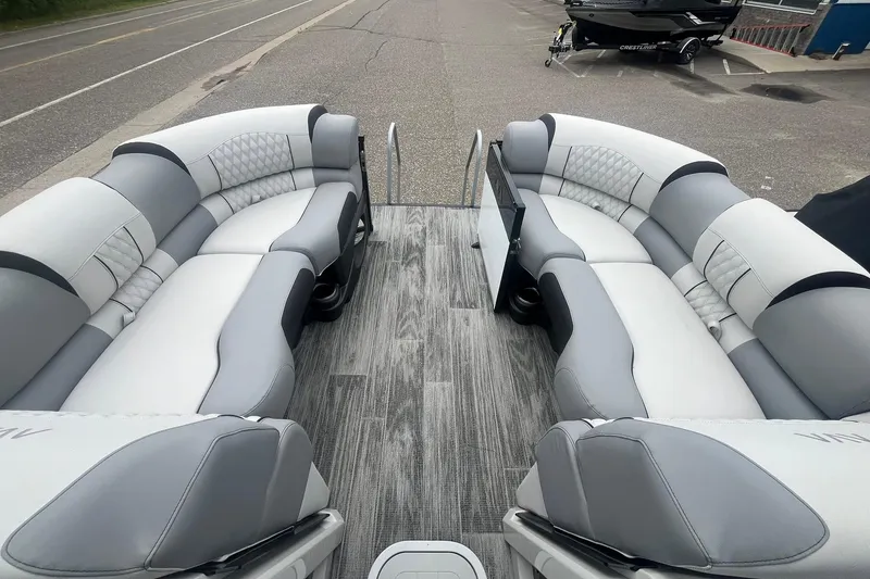 Slide: The Image of Luxurious 2025 Avalon Excalibur Versatile Rear Bench Windshield boat interior with plush seating. - 23