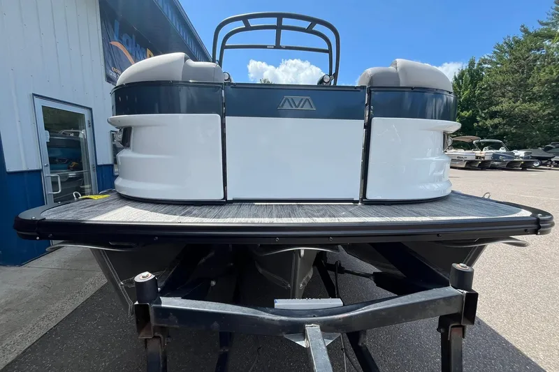 Slide: The Image of 2025 Avalon Excalibur Versatile Rear Bench Windshield boat on trailer, outdoor display. - 6