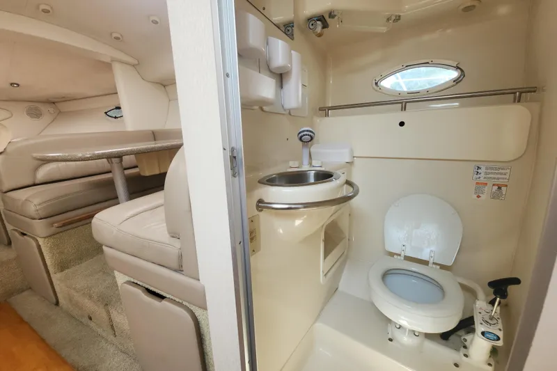 Slide: The Image of 2000 Maxum 3300 SCR boat interior with bathroom and seating area. - 11