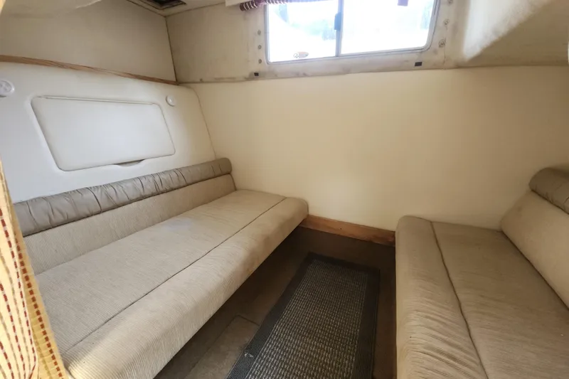 Slide: The Image of Interior cabin of 2000 Maxum 3300 SCR boat with beige seating and window. - 12