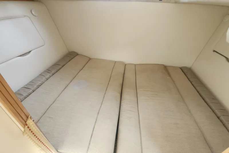 Slide: The Image of Interior cabin of 2000 Maxum 3300 SCR boat with beige cushions. - 14
