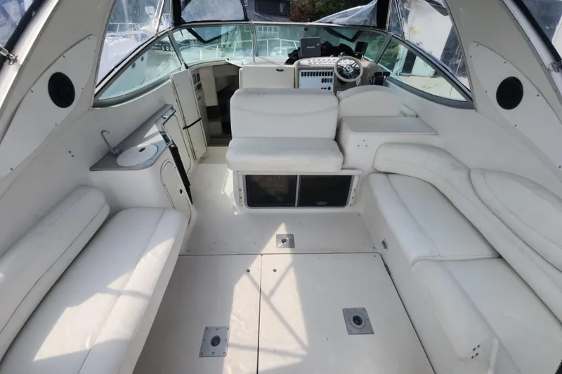 Slide: The Image of 2000 Maxum 3300 SCR boat interior with white seating and helm station. - 15