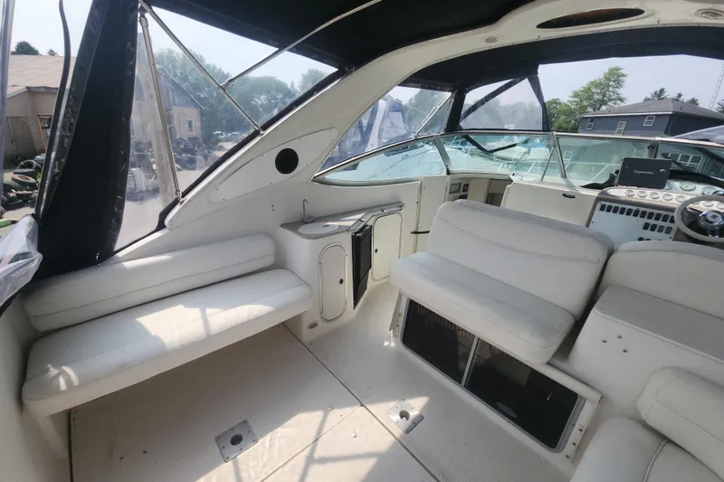 Slide: The Image of Interior of 2000 Maxum 3300 SCR boat with white seating and dashboard. - 4