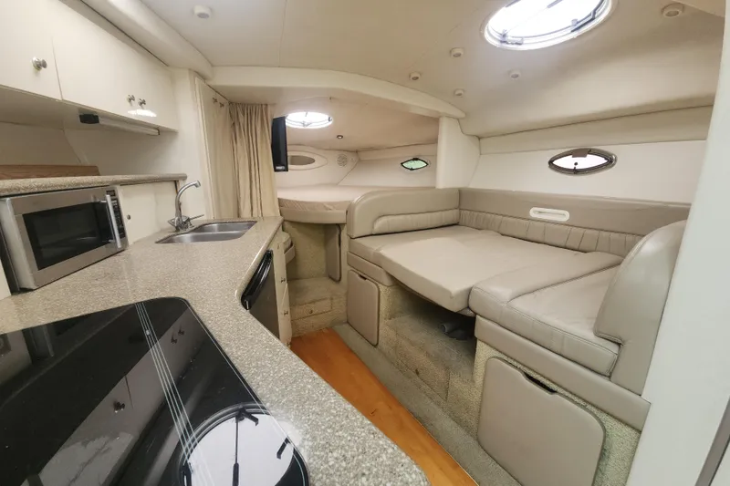 Slide: The Image of Interior of 2000 Maxum 3300 SCR yacht with kitchenette and seating area. - 7