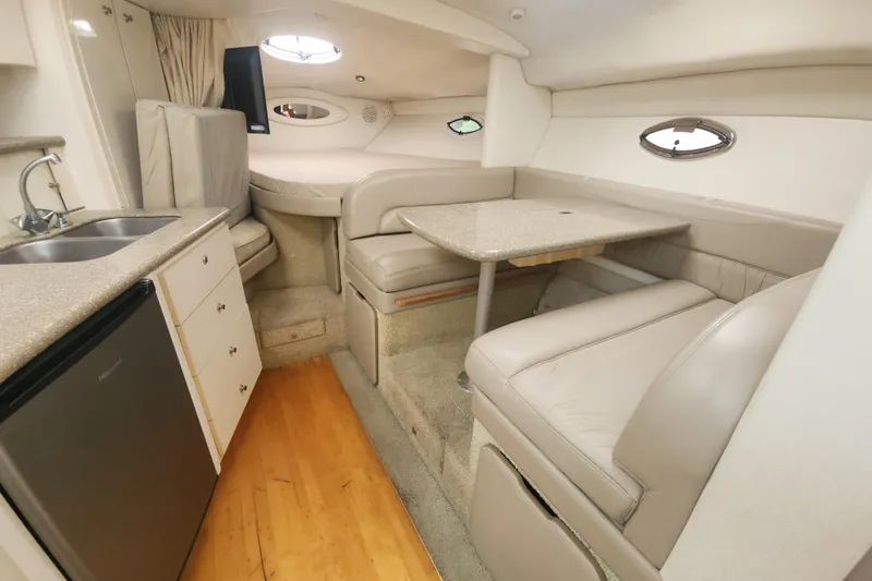 Slide: The Image of Interior of 2000 Maxum 3300 SCR yacht with kitchenette and seating area. - 9