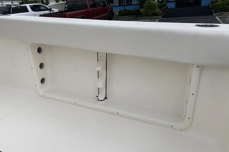 Slide: The Image of 2026 Bulls Bay 255CC boat interior detail with rod holders and storage compartment. - 12