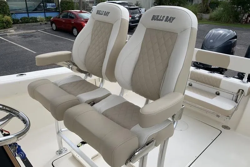 Slide: The Image of 2026 Bulls Bay 255CC boat seats with beige and white diamond stitching. - 14