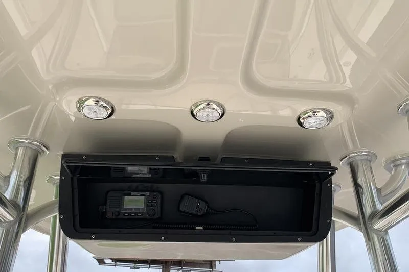 Slide: The Image of 2026 Bulls Bay 255CC boat console with radio and overhead lights. - 17