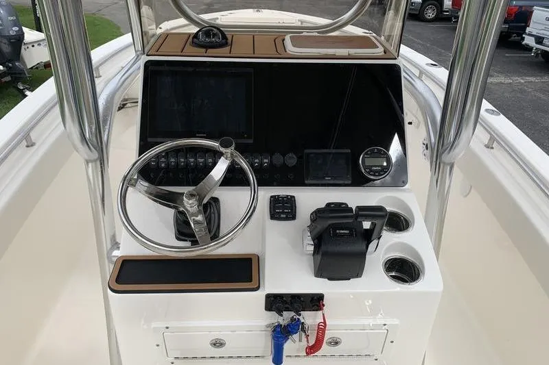 Slide: The Image of 2026 Bulls Bay 255CC boat console with steering wheel and navigation controls. - 18