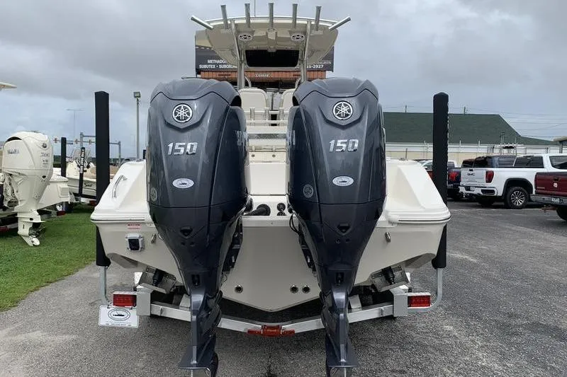 Slide: The Image of 2026 Bulls Bay 255CC boat with dual 150 horsepower outboard engines, rear view. - 2