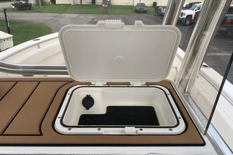 Slide: The Image of Open storage compartment on 2026 Bulls Bay 255CC boat deck. - 21