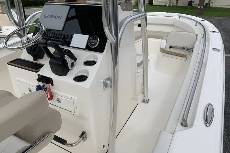 Slide: The Image of 2026 Bulls Bay 255CC boat interior with Garmin navigation system and seating area. - 23