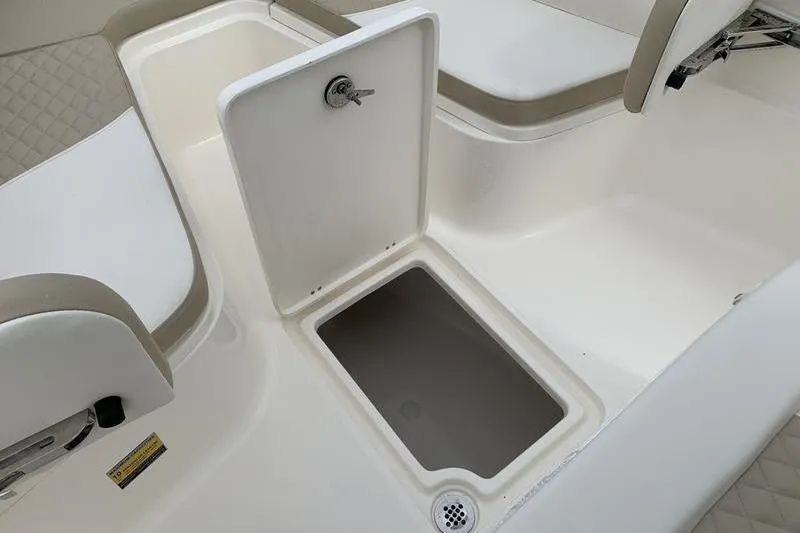 Slide: The Image of 2026 Bulls Bay 255CC boat interior with open storage compartment and seating. - 27