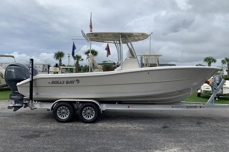 Slide: The Image of 2026 Bulls Bay 255CC boat on trailer, parked outdoors under cloudy sky. - 4