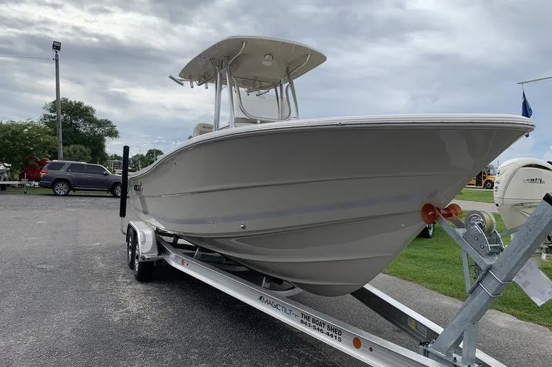 Slide: The Image of 2026 Bulls Bay 255CC boat on trailer, parked outdoors under cloudy sky. - 5