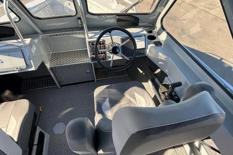Slide: The Image of 2025 Hewescraft 190 Sea Runner ET interior with steering wheel and seating. - 5
