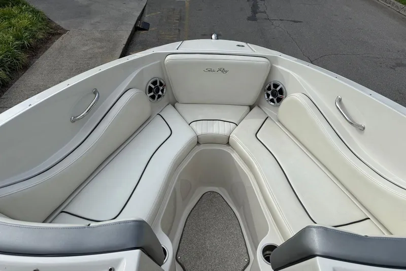 Slide: The Image of 2008 Sea Ray 230 Bow Rider Select interior with white seating and stainless steel accents. - 10