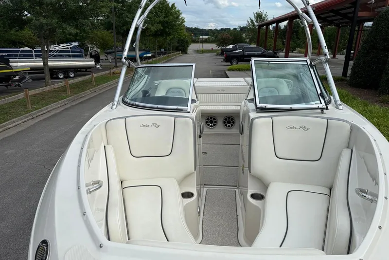 Slide: The Image of 2008 Sea Ray 230 Bow Rider Select with white interior, parked outdoors. - 11