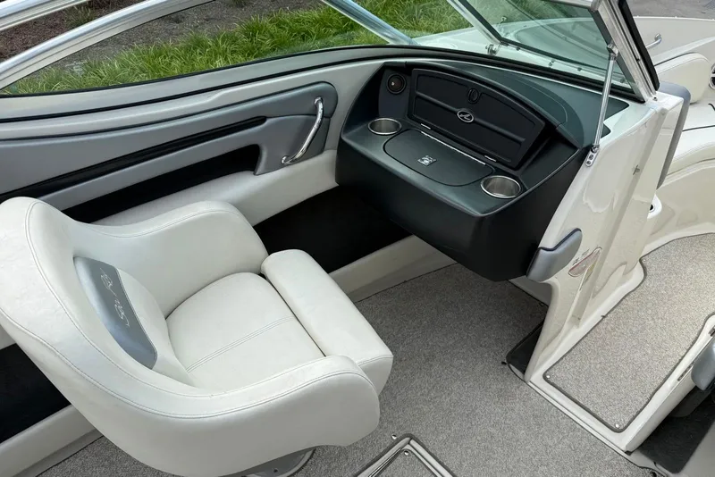 Slide: The Image of 2008 Sea Ray 230 Bow Rider Select interior with white seating and dashboard. - 12