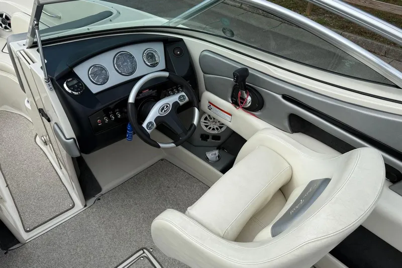 Slide: The Image of Interior view of a 2008 Sea Ray 230 Bow Rider Select boat cockpit. - 13
