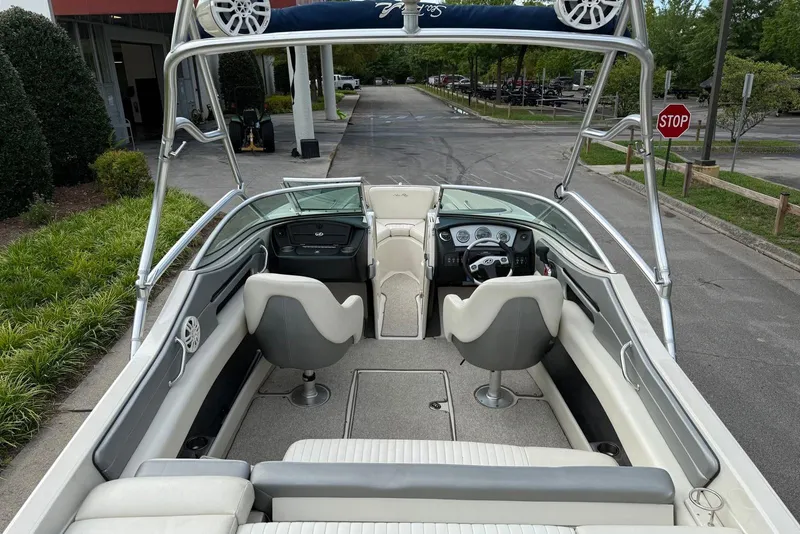 Slide: The Image of 2008 Sea Ray 230 Bow Rider Select interior with seating and dashboard view. - 9