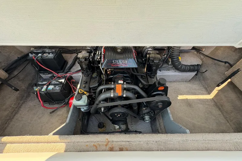 Slide: The Image of Engine compartment of a 1997 Chaparral 2130 Sport boat, featuring a 5.7L V8 engine. - 9