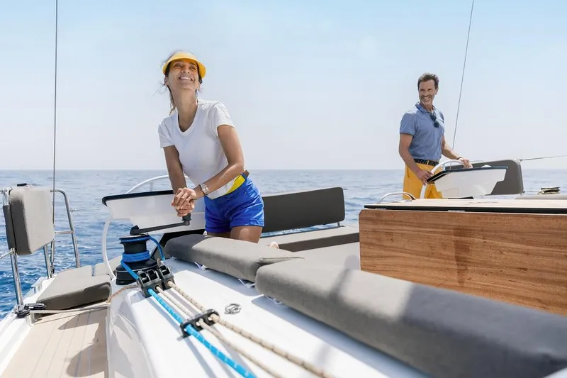 Slide: The Image of Couple sailing on a 2024 Dufour 41 yacht in open waters. - 5