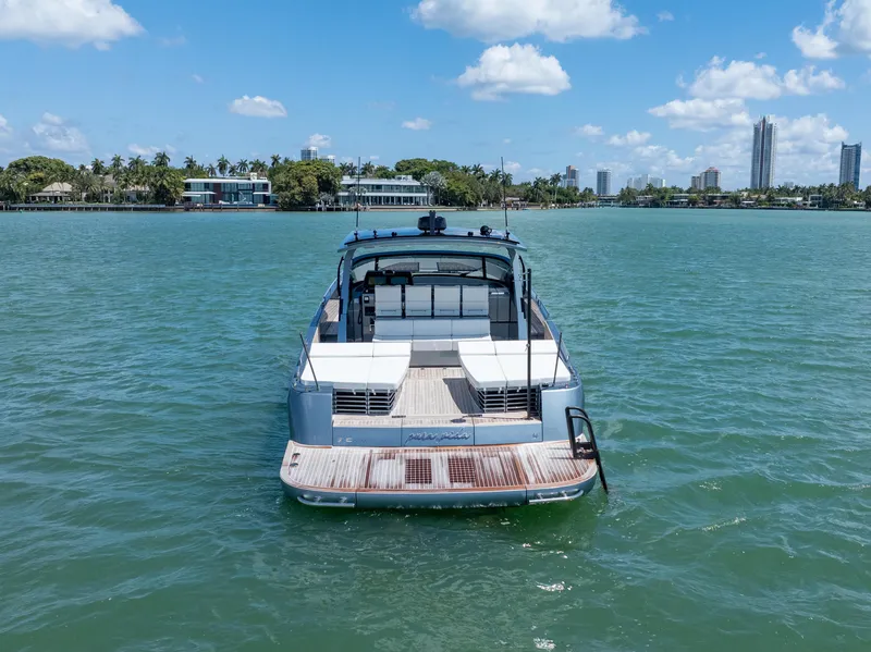 Slide: The Image of 2024 CNM CONTINENTAL 54 SuperSport yacht on calm water, city skyline in background. - 18