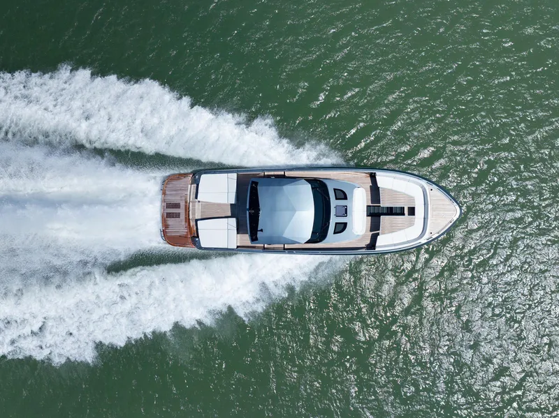 Slide: The Image of 2024 CNM CONTINENTAL 54 SuperSport yacht cruising on open water, aerial view. - 2