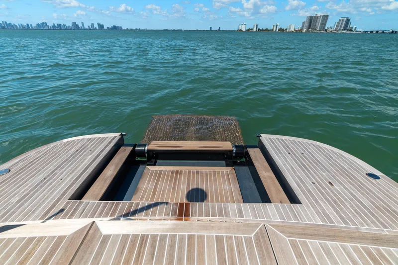 Slide: The Image of 2024 CNM CONTINENTAL 54 SuperSport yacht deck overlooking ocean and city skyline. - 20