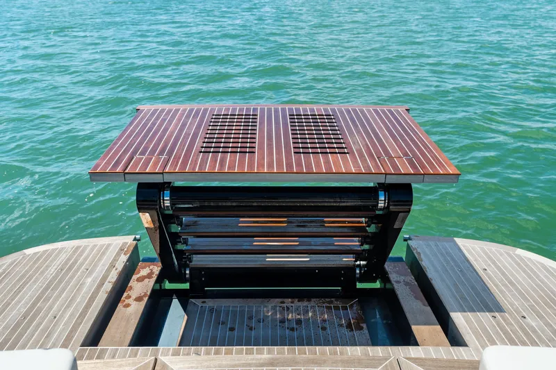 Slide: The Image of 2024 CNM CONTINENTAL 54 SuperSport yacht with a retractable deck feature on the water. - 21