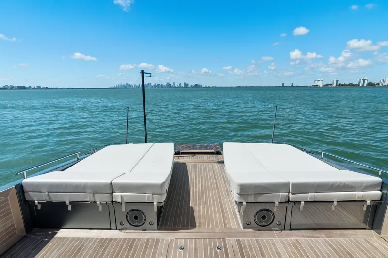 Slide: The Image of 2024 CNM CONTINENTAL 54 SuperSport yacht deck with sunbeds overlooking ocean. - 23