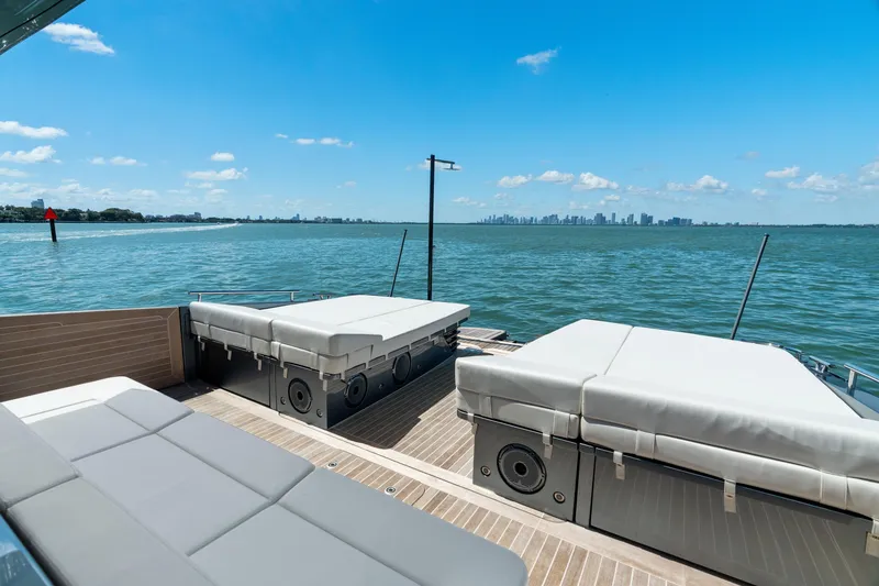 Slide: The Image of 2024 CNM CONTINENTAL 54 SuperSport yacht deck with sunbeds, overlooking serene ocean view. - 25