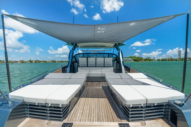 Slide: The Image of 2024 CNM CONTINENTAL 54 SuperSport yacht with sunbeds and canopy on open water. - 26