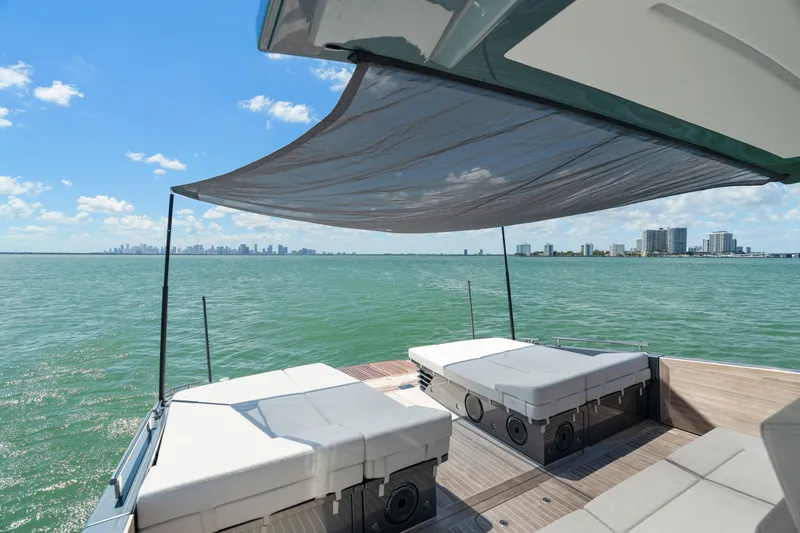 Slide: The Image of Luxurious 2024 CNM CONTINENTAL 54 SuperSport yacht with sunbeds and canopy on open water. - 27