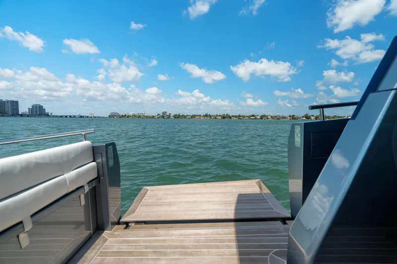 Slide: The Image of 2024 CNM CONTINENTAL 54 SuperSport yacht deck with ocean view under blue sky. - 30