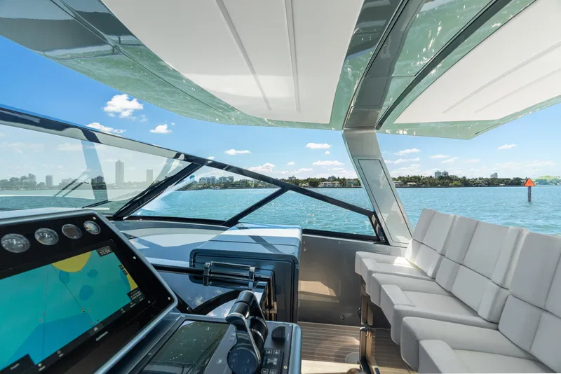 Slide: The Image of 2024 CNM CONTINENTAL 54 SuperSport yacht interior with modern navigation system and seating. - 34