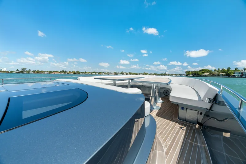 Slide: The Image of 2024 CNM CONTINENTAL 54 SuperSport yacht deck with ocean view under clear blue sky. - 43