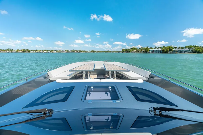 Slide: The Image of 2024 CNM CONTINENTAL 54 SuperSport yacht on serene blue waters under clear skies. - 44
