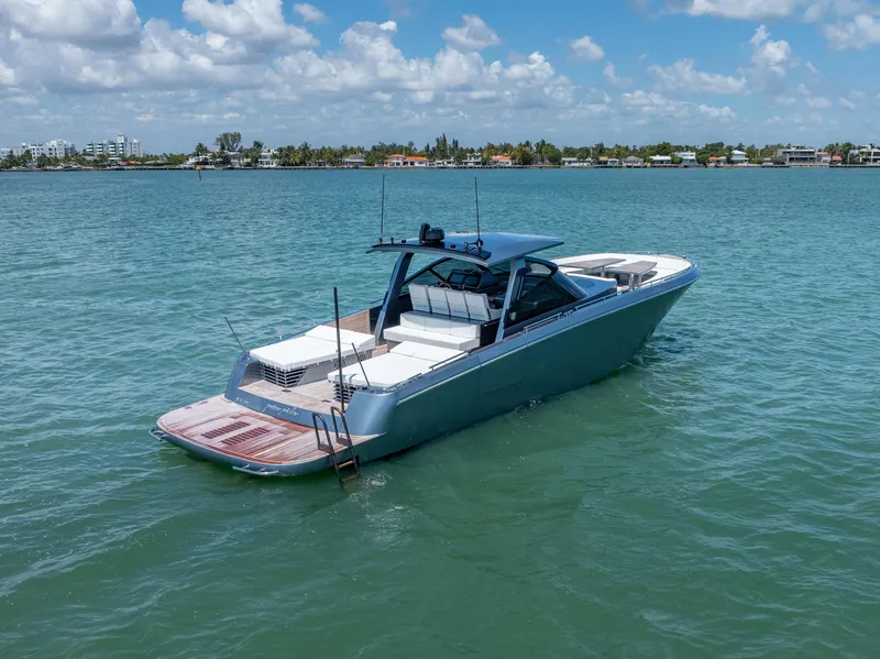 Slide: The Image of 2024 CNM CONTINENTAL 54 SuperSport yacht on calm water under blue sky. - 6