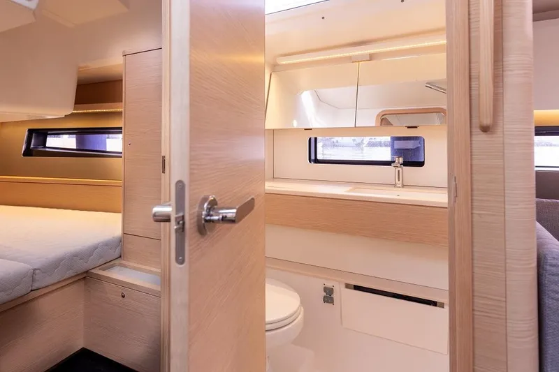 Slide: The Image of Interior of 2024 Dufour 41 yacht featuring bedroom and bathroom with modern design. - 14